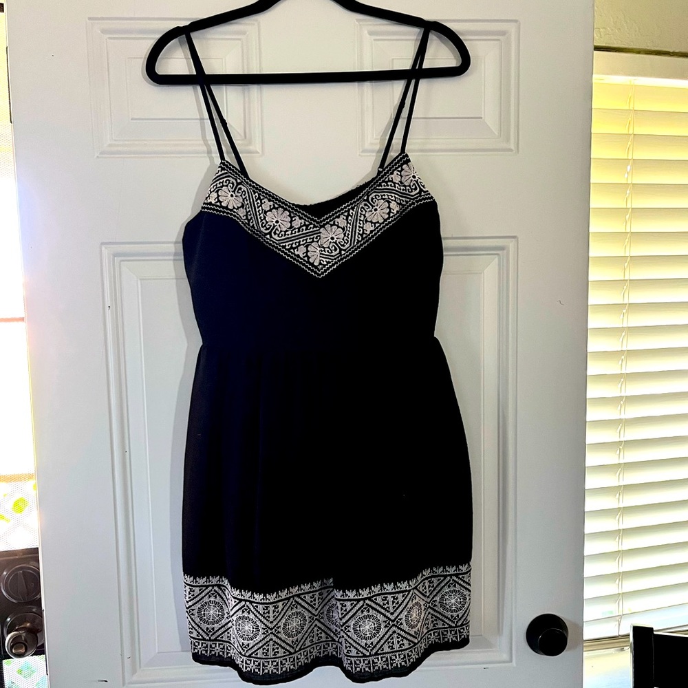 Black dress by Three Pink Hearts with white embroidered detail on top and hem